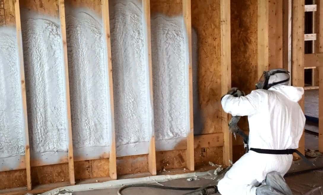 Attic Vac technician applying spray foam insulation in a Toronto home